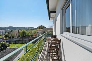 a balcony with two chairs and a table on it at Vitóriahouse - Your Little Corner in Vila Nova de Gaia