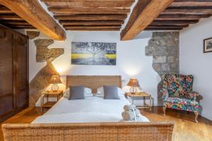 a bedroom with a bed and a chair at Appartamento del Campo - Siena in Siena