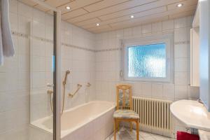 a bathroom with a tub and a sink at Ferienwohnung Gabriele in Lauf +27 photos