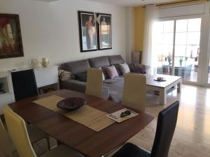 a living room with a table and a couch at Sitges Llum House in Sitges