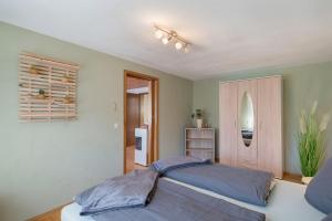 a bedroom with a large bed with blue pillows at Ferienwohnung Gabriele in Lauf