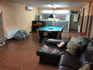 a living room with a couch and a pool table at Sitges Llum House in Sitges
