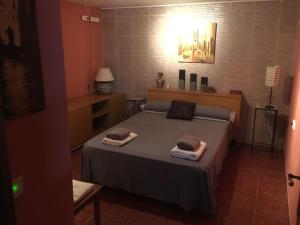 a bedroom with a bed with two towels on it at Sitges Llum House in Sitges