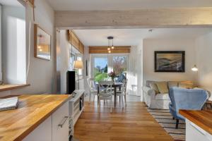 a kitchen and living room with a couch and a table at Ferienwohnungen in Neufeld in Neufeld
