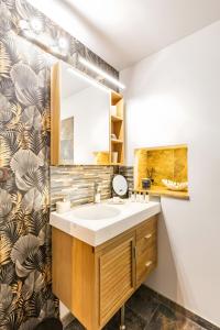 a bathroom with a sink and a mirror at Gîte L'étable in Sales +15 photos