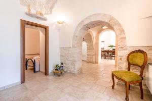 a living room with a stone archway and a table at Trulli Orma in Martina Franca