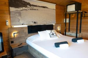 a bedroom with two beds and a picture of a beach at Les Chalets De Tesa in Occhiatana +19 photos