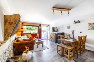 a living room with a couch and a table at Gîte L'étable in Sales
