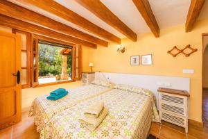 a bedroom with a bed with towels on it at Can Colau in Santa Margalida +24 photos