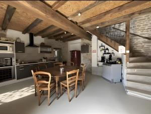 a kitchen and dining room with a table and chairs at Gite de scène in Chamesson