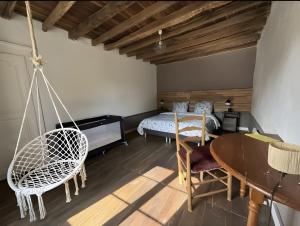 a bedroom with a bed and a table and chairs at Gite de scène in Chamesson +8 photos