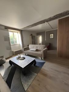 a living room with a couch and a coffee table at Gite de scène in Chamesson