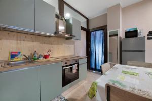 a kitchen with a sink and a stove top oven at La Casa di Lu - Val D'Intelvi in Lanzo dʼIntelvi +14 photos