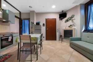 a living room with a table and chairs and a couch at La Casa di Lu - Val D'Intelvi in Lanzo dʼIntelvi