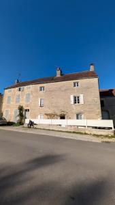 a large brick building on the side of a street at Gite de scène in Chamesson