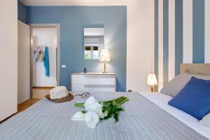 a blue bedroom with a bed with a stuffed animal on it at Appartamento Marilu Lake View in Brenzone sul Garda