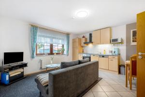 a living room with a couch and a kitchen at Am Tivoli in Hermeskeil +14 photos
