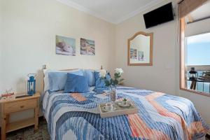 a bedroom with a bed with a tray with flowers on it at Marazul in Tacoronte