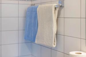 a bathroom with blue and white towels on a wall at Fewo Brünnstein - Nr 61 Pool, Sauna in Oberaudorf +16 photos