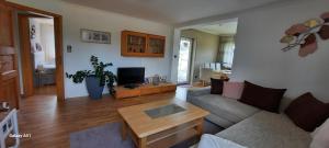 a living room with a couch and a coffee table at Ferienwohnung an der Lahn in Limburg an der Lahn