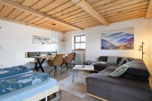 a living room with a couch and a table at Ferienwohnung Geyersberg 704 in Hauzenberg