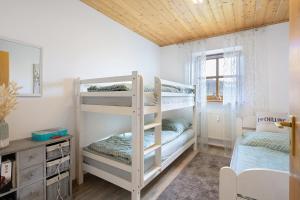 a room with two bunk beds and a desk at Ferienwohnung Geyersberg 704 in Hauzenberg +36 photos