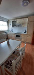 a kitchen with a table and chairs in it at Ferienwohnung an der Lahn in Limburg an der Lahn