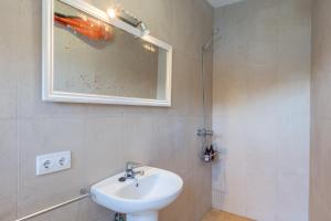 a bathroom with a white sink and a mirror at Villa Banyalbufar in Banyalbufar +34 photos