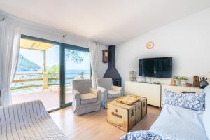 a living room with a view of the ocean at Villa Banyalbufar in Banyalbufar