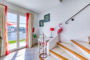 a room with a balcony with a flamingo on the wall at Petite maison Aigues Mortes in Aigues-Mortes +21 photos
