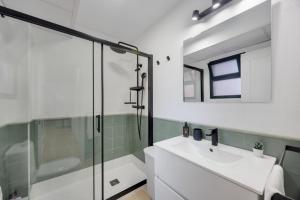 a bathroom with a glass shower and a sink at Casa Siempreviva in Tarifa +12 photos