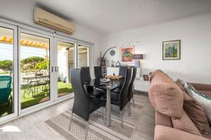 a living room with a table and chairs and a couch at Casa Gudrun in Praia do Carvoeiro