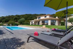 a villa with a swimming pool and a house at Les Hauts de Figha in Conca
