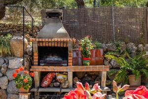 a bird house sitting on a table in a garden at Es Porcho in Deia