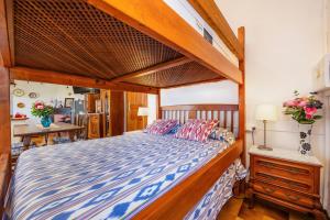 a bedroom with a large bed with a wooden frame at Es Porcho in Deia
