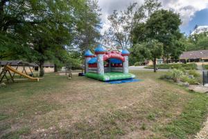 a playground in a park with a slide at Mobilhome Le Cocon in Saint-Pompont