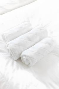 an unmade bed with white sheets and pillows at Strand in Böhl