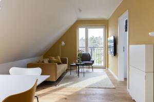 a living room with a couch and a table at Strand in Böhl