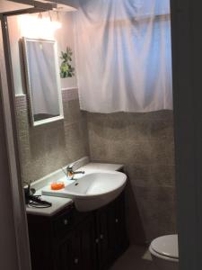 a bathroom with a sink and a toilet and a mirror at Affittacamere Roma Tiburtina in Rome
