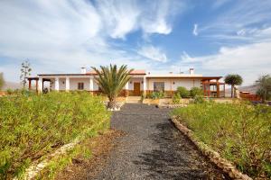 a house in the middle of a field at Casa Glory in Antigua