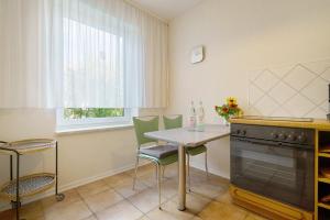 a kitchen with a table and chairs and a window at Haus Grün in Templin