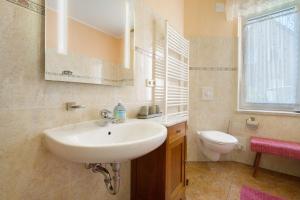 a bathroom with a sink and a toilet at Haus Grün in Templin +17 photos