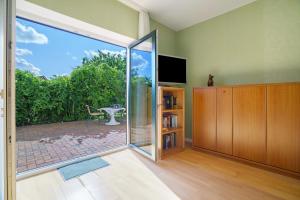 a living room with a sliding glass door to a patio at Haus Grün in Templin