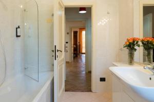a bathroom with a sink and a glass shower at Art Rooms in Arezzo +53 photos