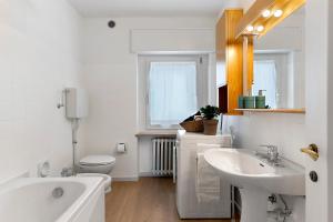 a bathroom with a tub and a sink and a toilet at The View in Levico Terme +21 photos