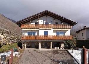 a large house with a deck on top of it at The View in Levico Terme