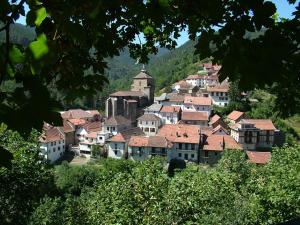 a town on a hill with houses and a church at Kabila Enea 1 in Uztárroz +4 photos