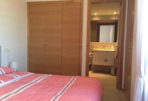 a bedroom with a bed and a bathroom with a sink at Fantastic apartment in Torrevieja +21 photos