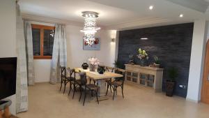 a dining room with a table and chairs and a chandelier at Casa las Columnas in Capdepera