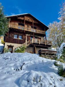 a log cabin with snow in front of it at Le Flocon Grand Chalet 4 étoiles in Villard-Reculas